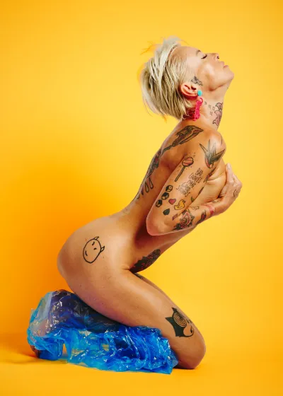 Lu Epic fully nude in an erotic art series eating and smearing papaya fruit across her face and body