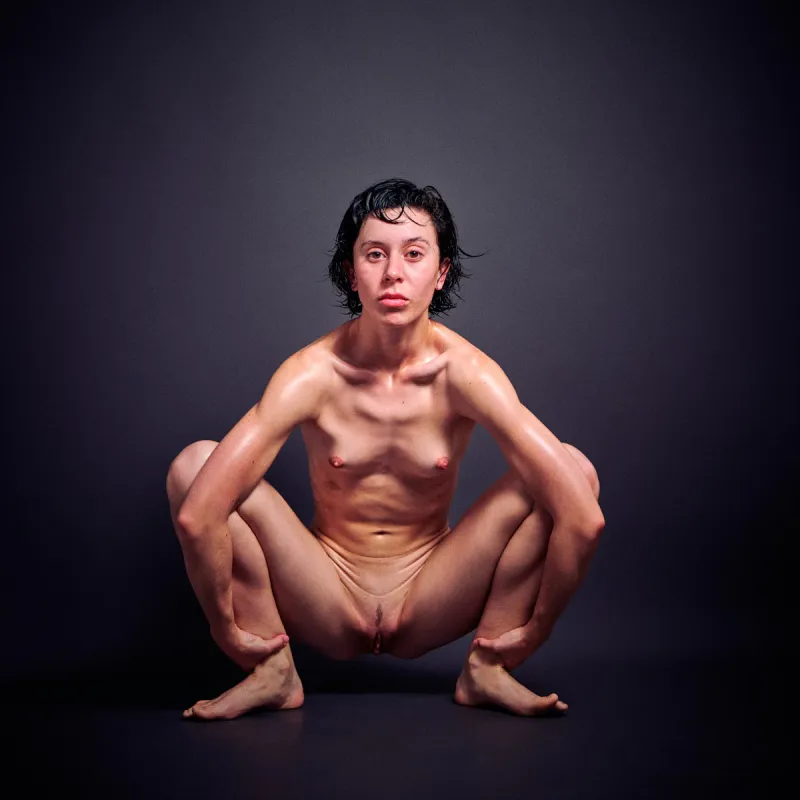 German model Ulah Bauer Nude oiled skin extreme explicit pose dark backdrop Barcelona photographer Cinaed Dane