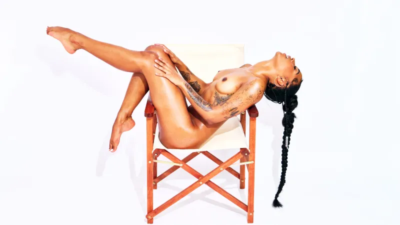 Erotic nude art portrait of African Beauty posed confidently on a chair