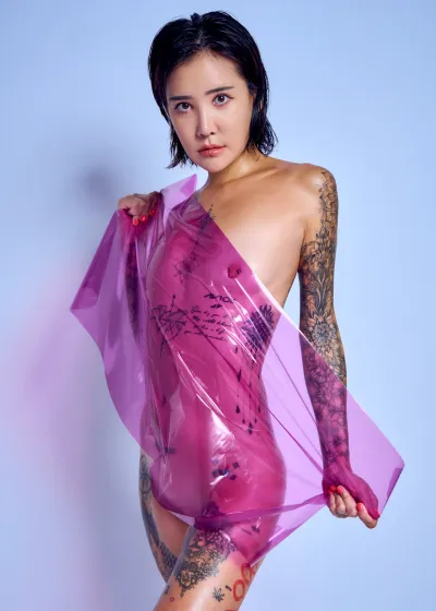 South Korean tattooed model Chloe Purple Wrap purple cellophane expressive nude light blue backdrop Barcelona photographer Cinaed Dane
