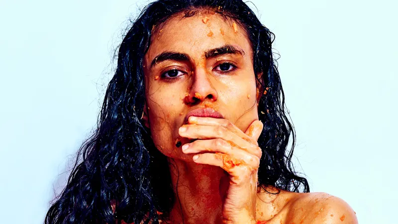 Bold erotic fine art portrait emphasizing playful texture, vibrant color, and confident posture